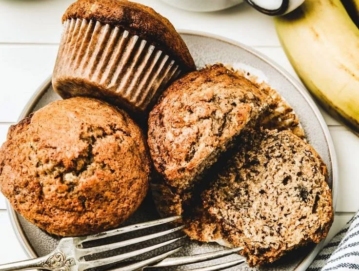 Freshly baked banana bread muffins on a cooling rack