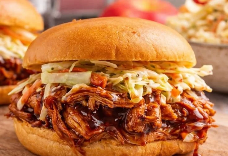 Delicious BBQ Pulled Chicken served on a bun with coleslaw