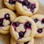 Freshly baked Blueberry Cheesecake Cookies on a cooling rack