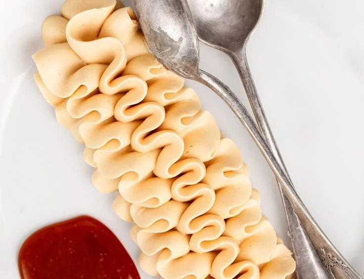 Delicious homemade caramel frosting spread on a chocolate cake.