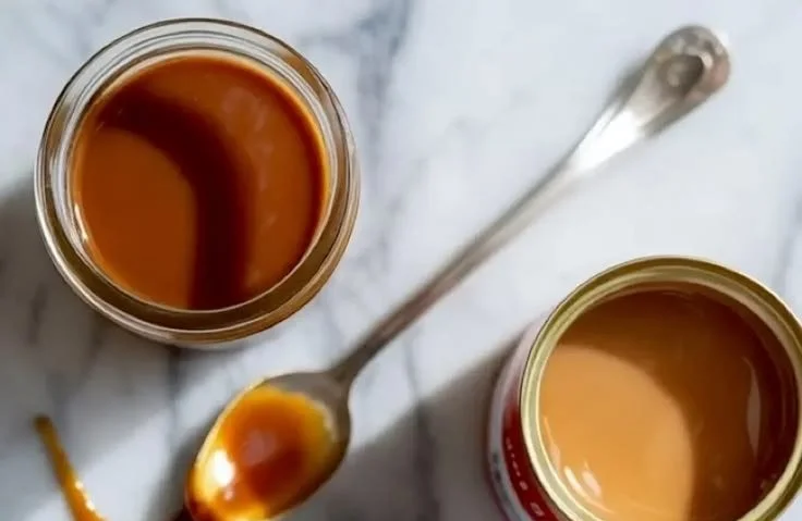 Delicious caramel sauce made from condensed milk in a glass jar.