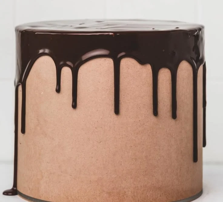 A stunning Chocolate Drip Cake with luscious chocolate glaze and decorative toppings.
