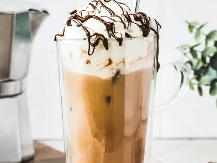 Refreshing chocolate iced coffee topped with whipped cream and chocolate shavings