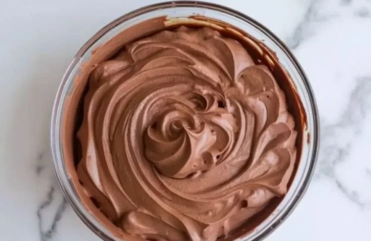 Decadent chocolate mousse cake filling on a dessert plate