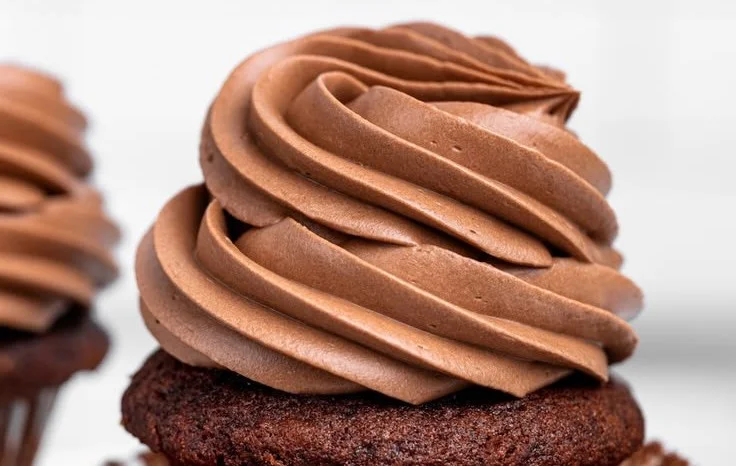 Chocolate Swiss Meringue Buttercream spread on a decadent cake