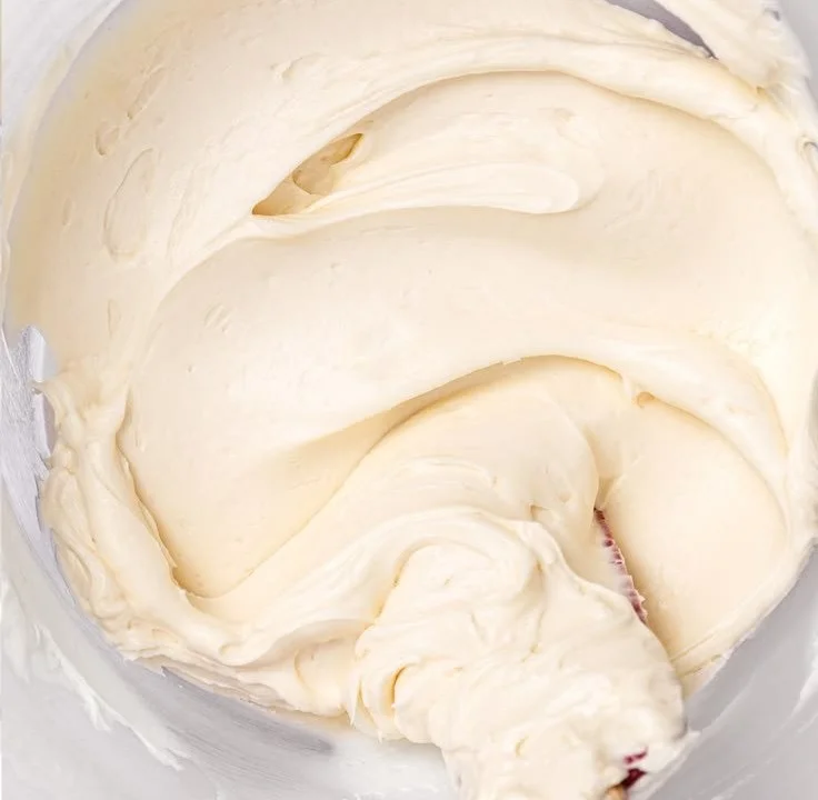 Bowl of classic vanilla buttercream frosting with a spatula