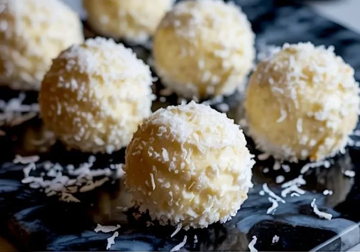 Delicious Coconut Snowball Cheesecake Bites topped with coconut flakes