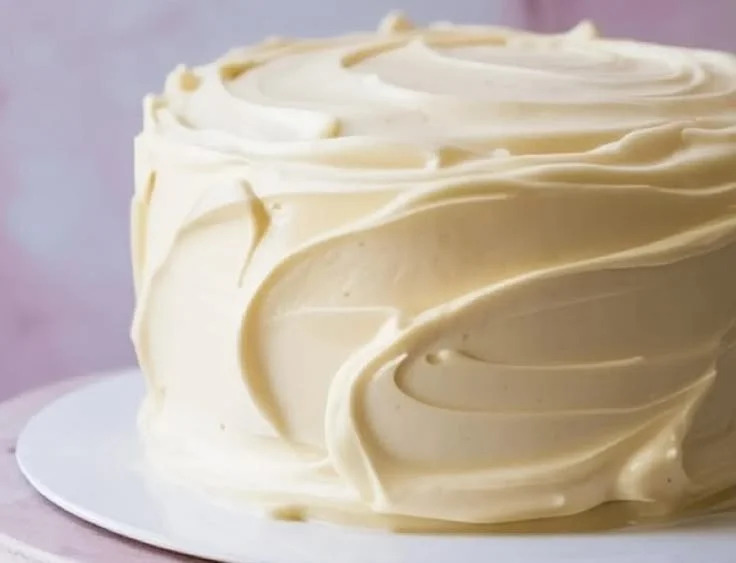 Delicious cream cheese frosting on a cake slice