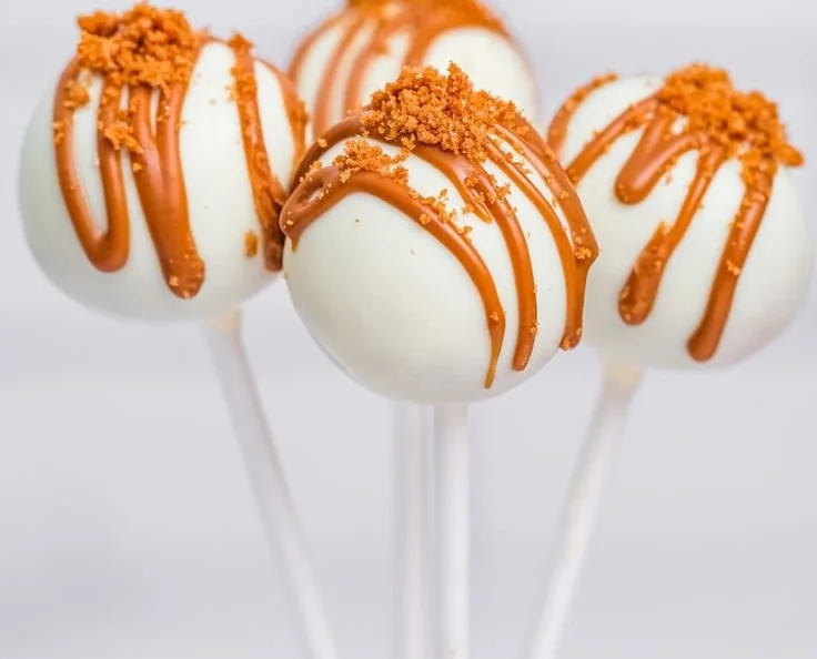Delicious creamy Biscoff cake pops decorated with crumbled Biscoff cookies.