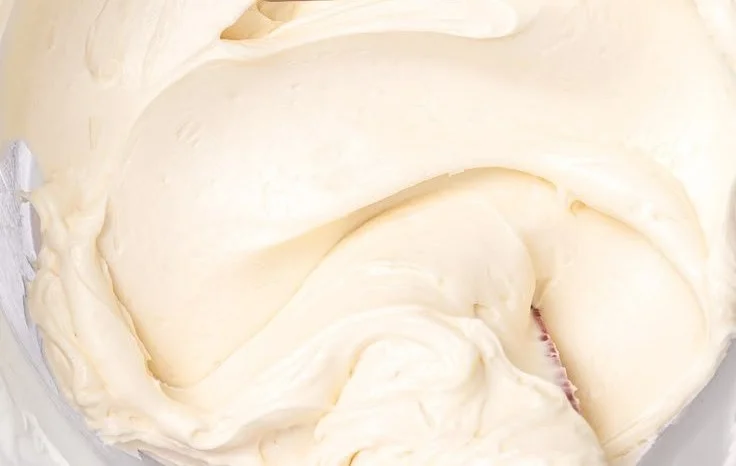 Bowl of easy buttercream frosting ready to decorate cakes and cupcakes