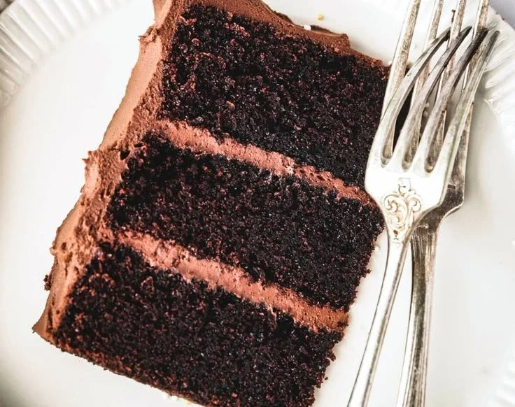 Easy chocolate birthday cake topped with chocolate frosting and sprinkles.