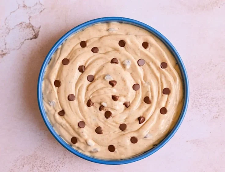 Bowl of easy cookie dough dip served with chocolate chips and graham crackers
