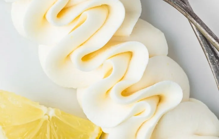Delicious easy lemon frosting spread on a cupcake