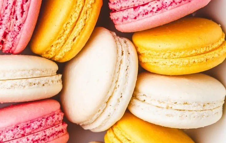 Colorful assortment of homemade French Macarons on a decorative plate.