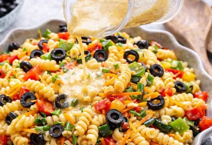 Colorful Italian pasta salad with fresh vegetables and herbs