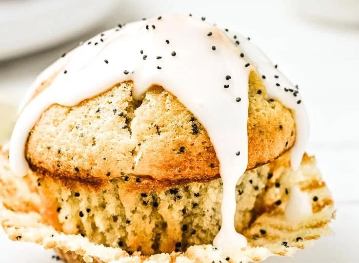 Freshly baked lemon poppy seed muffins on a wooden table