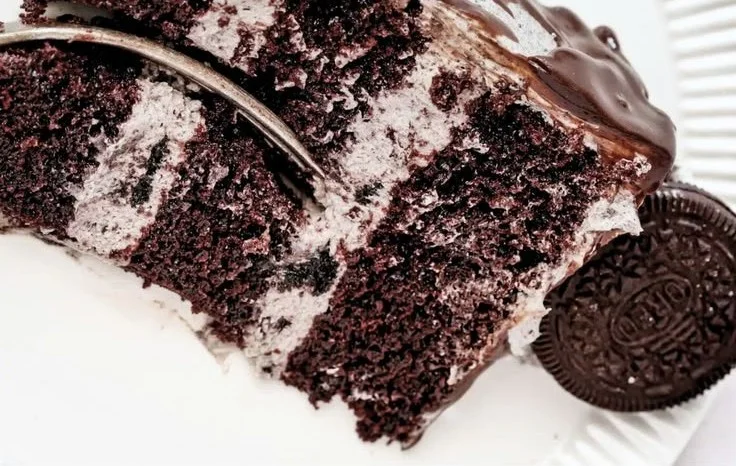 Delicious homemade Oreo Birthday Cake decorated with Oreo cookies and cream.