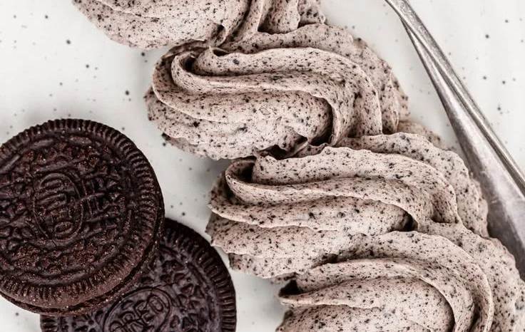 Oreo Buttercream Frosting on a cupcake topped with Oreo cookie crumbs.