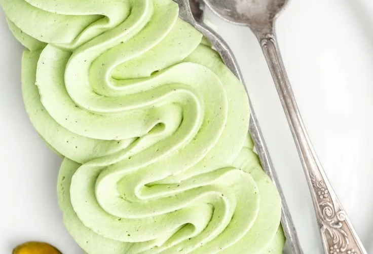 Pistachio whipped cream frosting on a cake