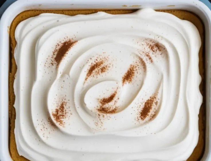 Delicious Pumpkin Three Milks Cake with creamy topping and golden pumpkin decoration