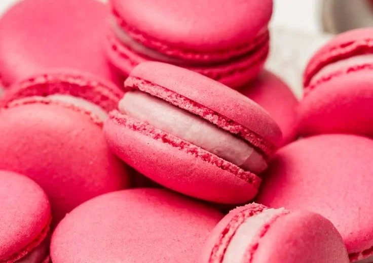 Delicious Raspberry Macarons with a vibrant pink hue and smooth filling.