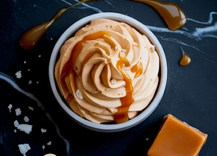 Delicious salted caramel buttercream frosting on a vanilla cupcake