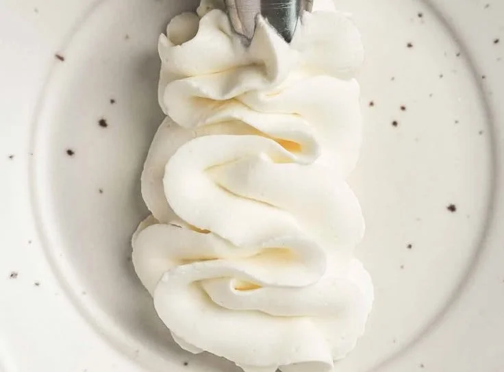 Delicious stabilized whipped cream cheese frosting on a cake