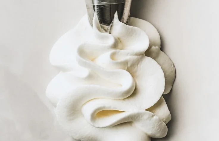 Stabilized whipped cream frosting ready to decorate a cake.
