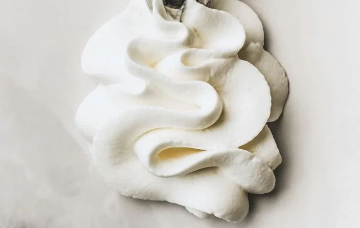 Stabilized whipped cream frosting on a decorated cake