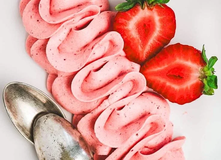 Delicious strawberry buttercream frosting on a cupcake