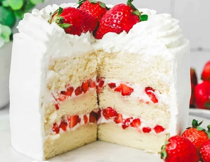 Delicious Strawberry Chantilly Cake topped with fresh strawberries and whipped cream.