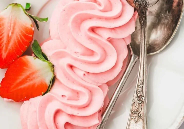 Delicious strawberry cream cheese frosting spread over a cake.