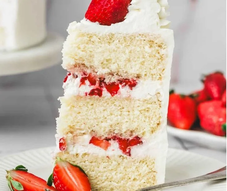 A delicious Strawberry Mascarpone Cake topped with fresh strawberries and mascarpone cream.