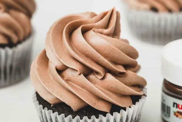 Delicious Swiss Buttercream frosting on a cake with decorative piping.