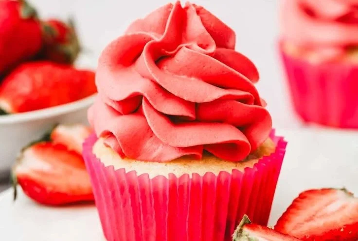 Whipped strawberry ganache filling in a pastry, rich and creamy texture.