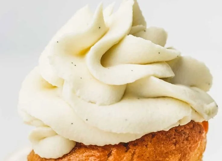 Delicious white chocolate ganache frosting on a cake slice