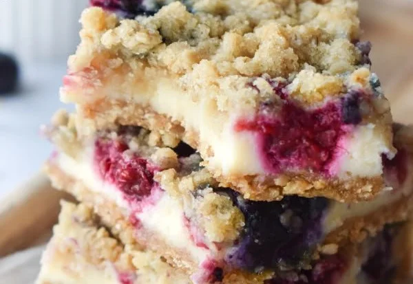 Blueberry cream cheese squares served on a plate with fresh blueberries