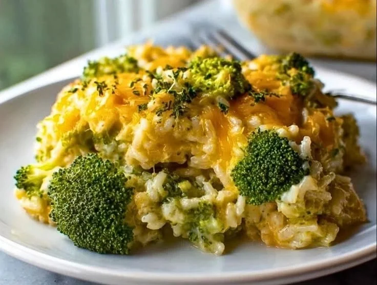 Delicious Broccoli Cheese Rice Casserole topped with melted cheese and fresh broccoli