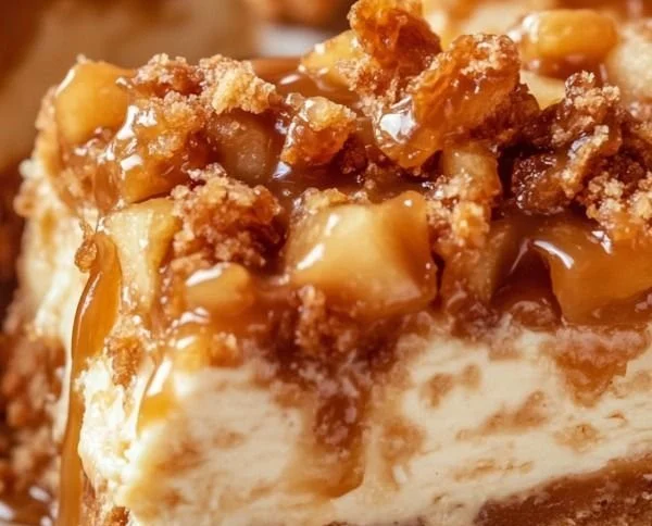 Delicious caramel apple cheesecake bars topped with caramel drizzle.