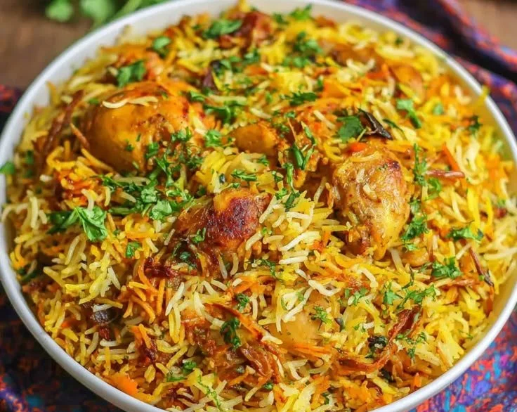 A delicious plate of Chicken Biryani garnished with spices and herbs