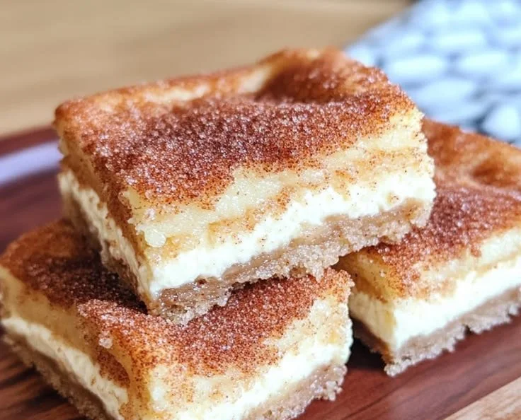 Delicious churro cheesecake bars topped with cinnamon sugar