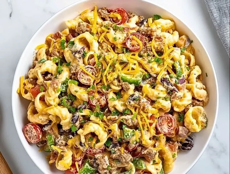 Colorful Cowboy Pasta Salad with vegetables and dressing in a bowl