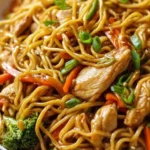 Delicious easy chicken lo mein served in a bowl with vegetables and noodles.