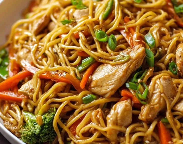 Delicious easy chicken lo mein served in a bowl with vegetables and noodles.