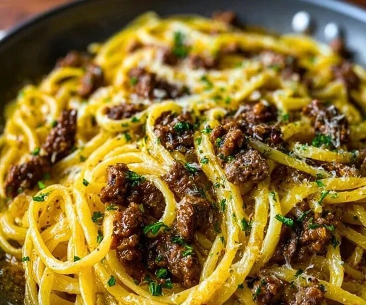 Delicious Garlic Butter Beef Pasta served in a bowl with herbs.