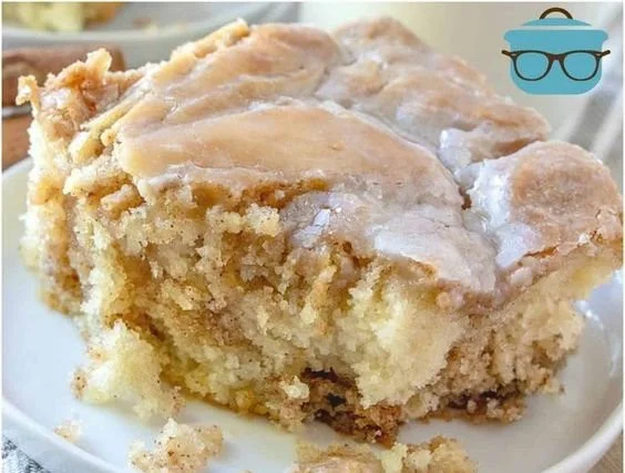 Delicious homemade cinnamon roll cake topped with icing on a plate