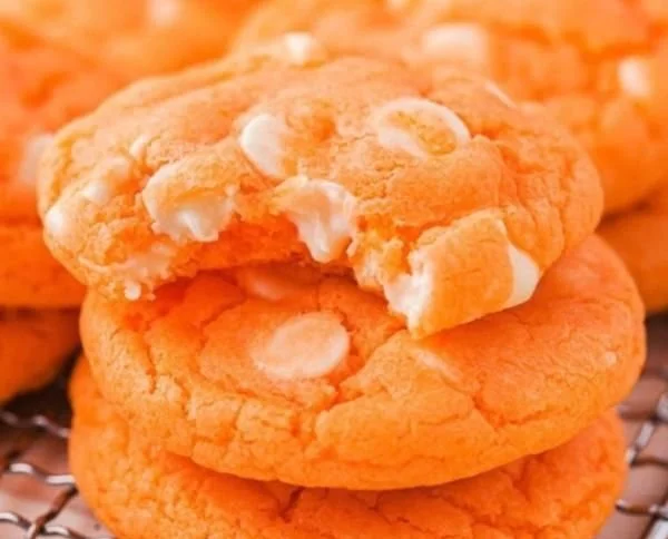 Orange Creamsicle Cookies with vibrant orange icing and creamy filling