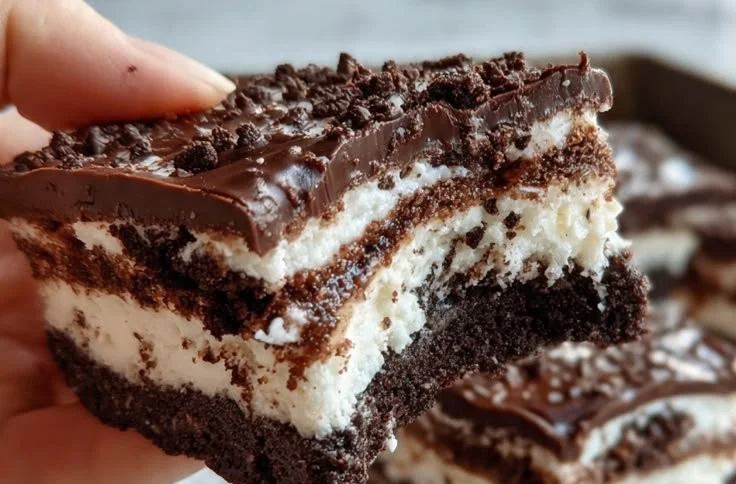 Delicious Oreo layered dessert bars with cream and chocolate topping