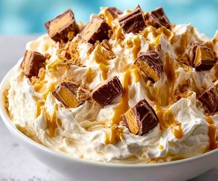 Delicious Reese's Peanut Butter Fluff dessert topped with chocolate and peanuts.