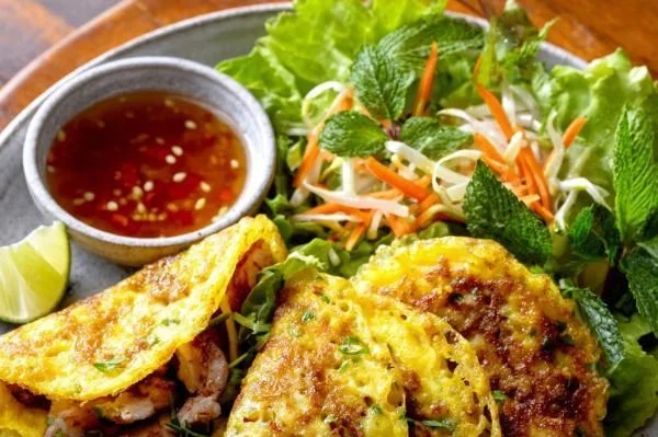 Easy Vietnamese Pho-style Banh Xeo pancakes garnished with fresh herbs